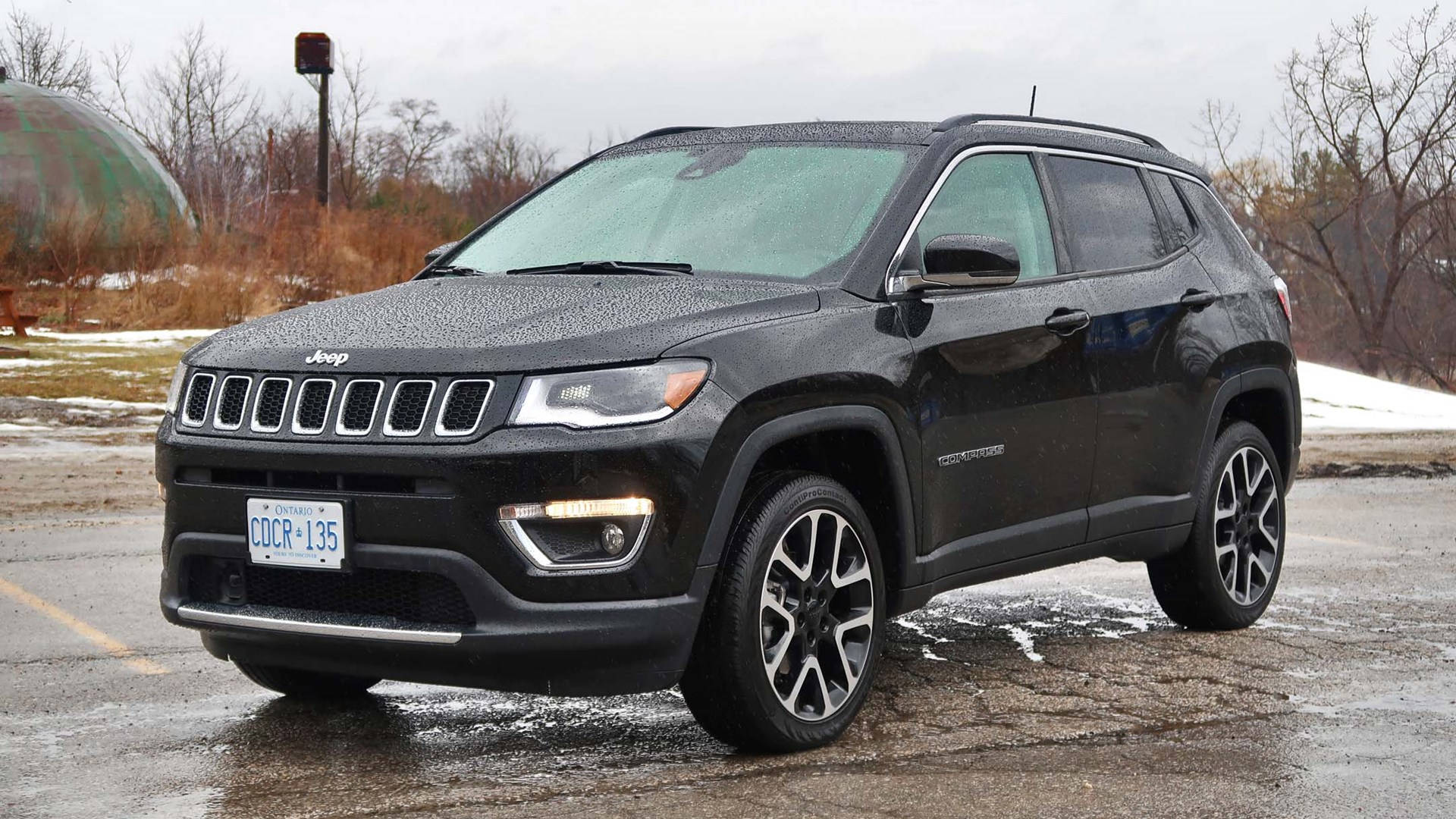 Captivating Black Jeep Compass on a Wet Road Wallpaper