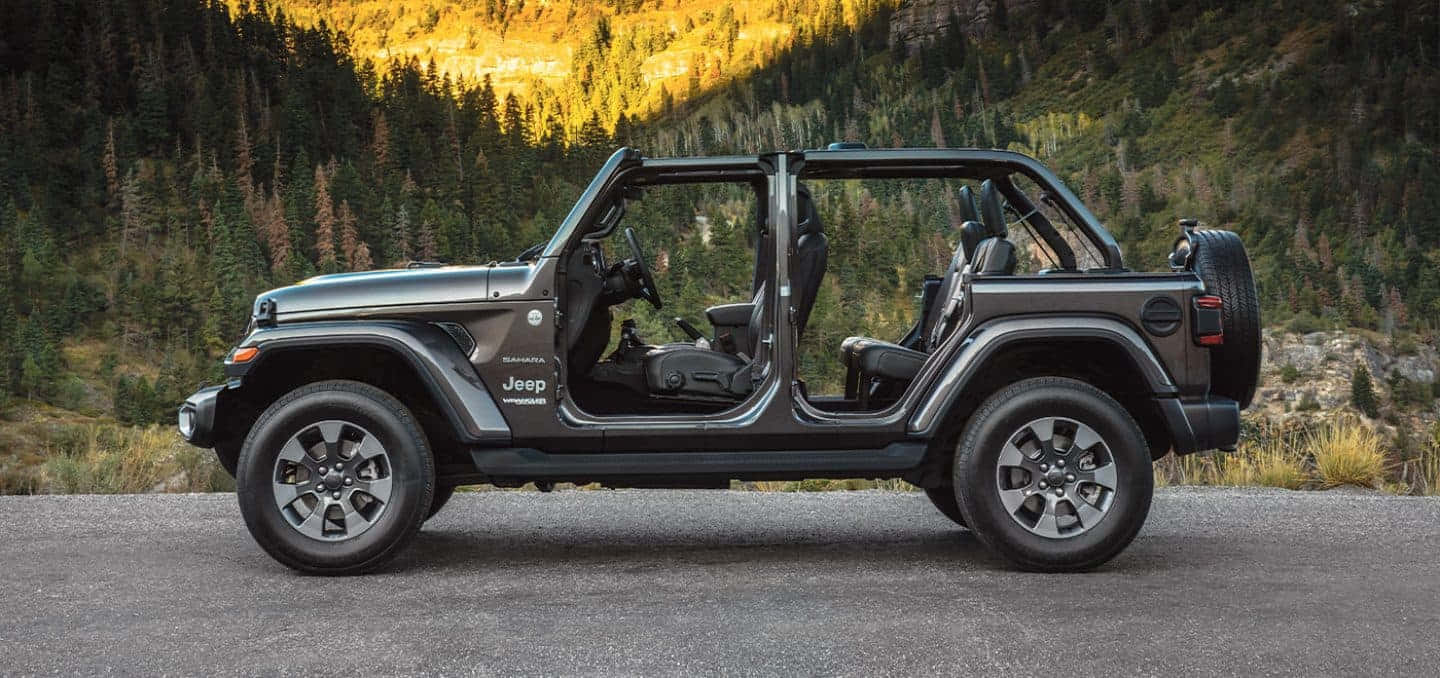 The 2019 Jeep Wrangler Is Parked In A Mountain Road