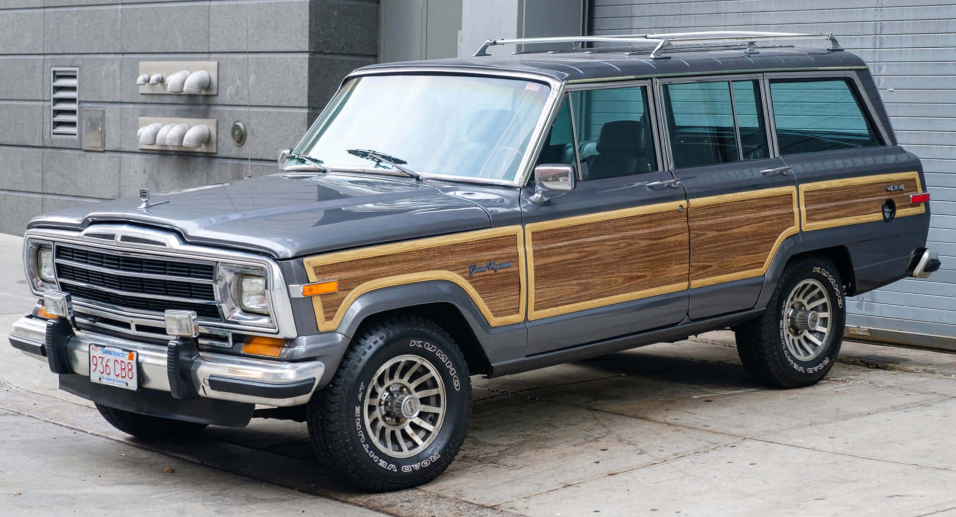 Classic Jeep Wagoneer conquering a picturesque off-road trail Wallpaper