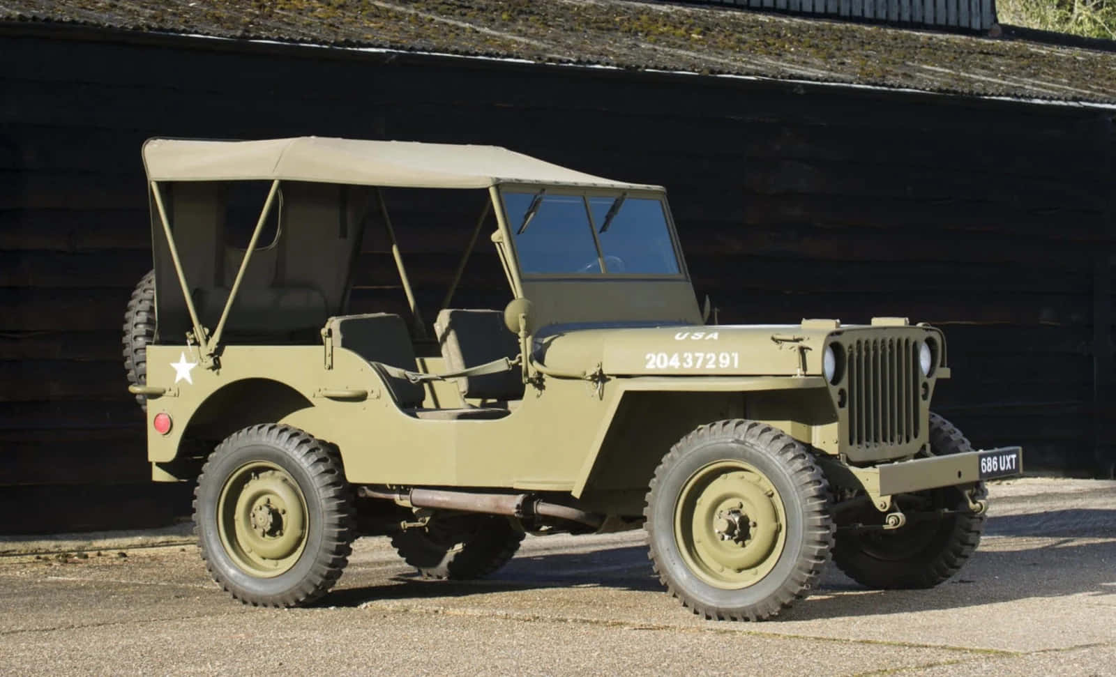 Vintage Jeep Willys in rugged terrain Wallpaper