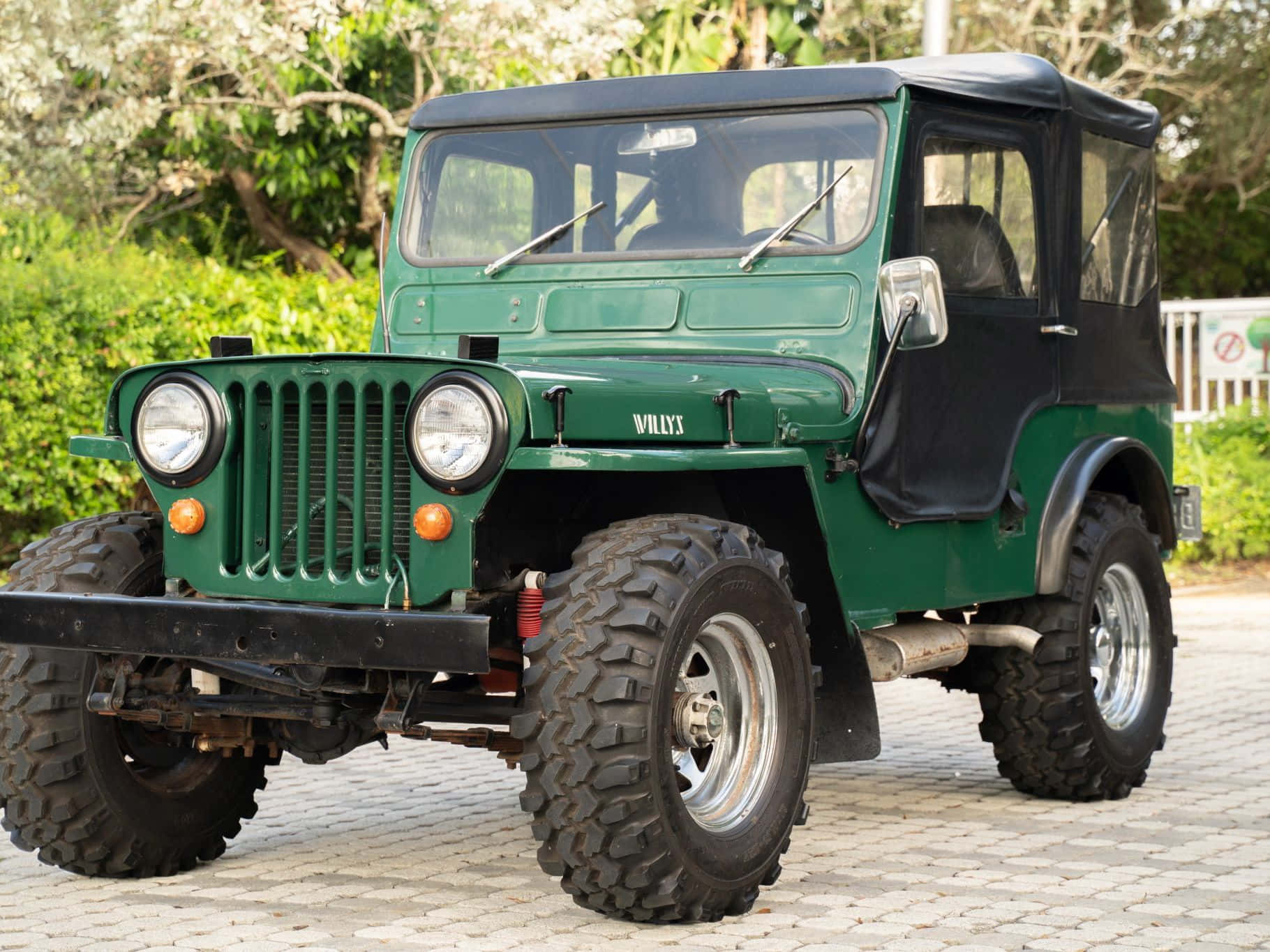 Iconic Jeep Willys in a picturesque landscape Wallpaper