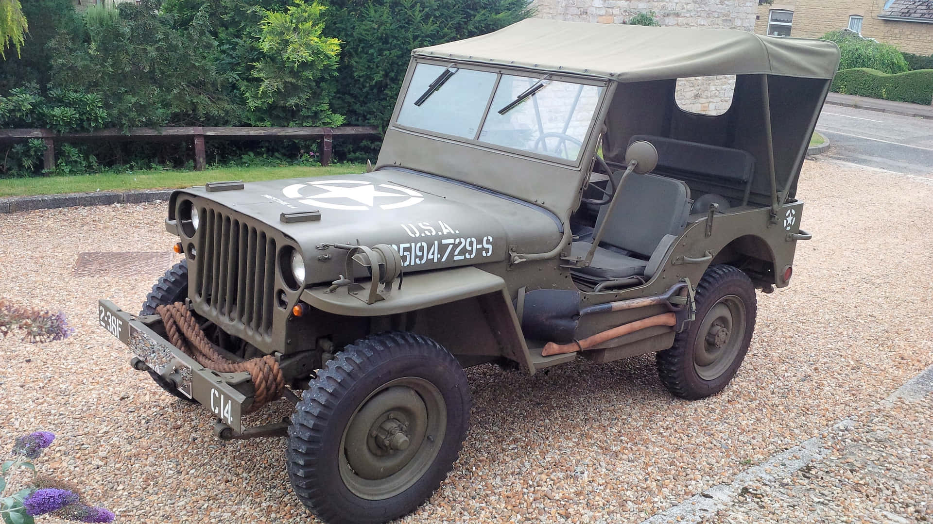 Vintage Jeep Willys conquering off-road terrain Wallpaper