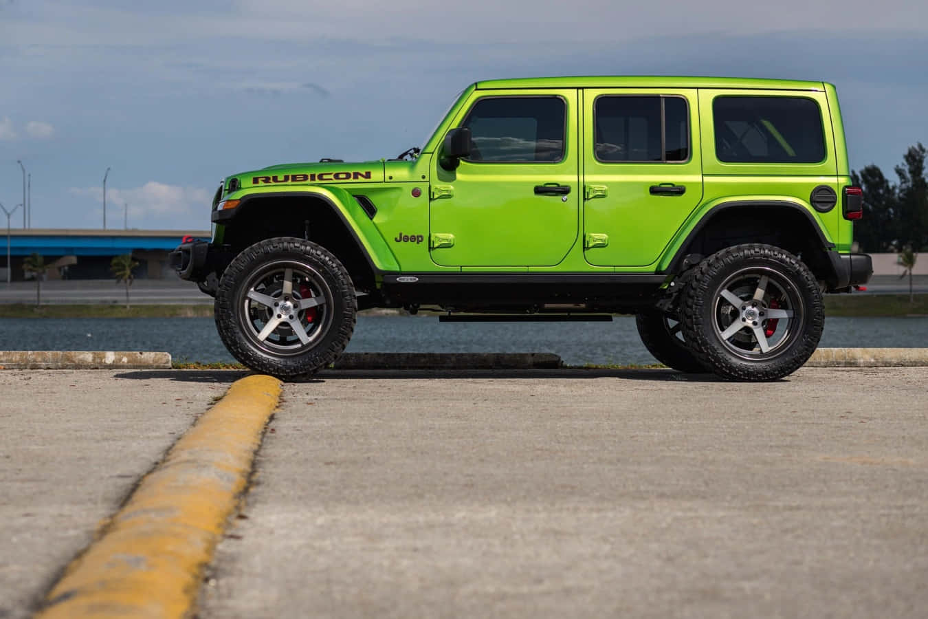 A Green Jeep Parked On A Parking Lot