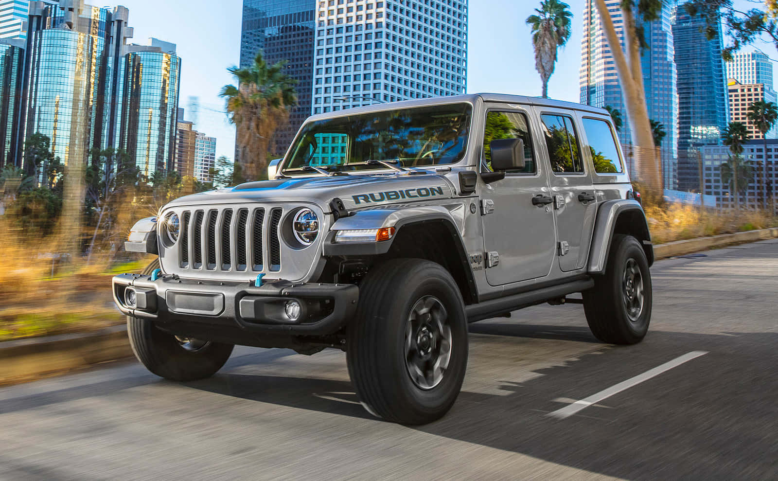 The 2020 Jeep Wrangler Is Driving Down A City Street