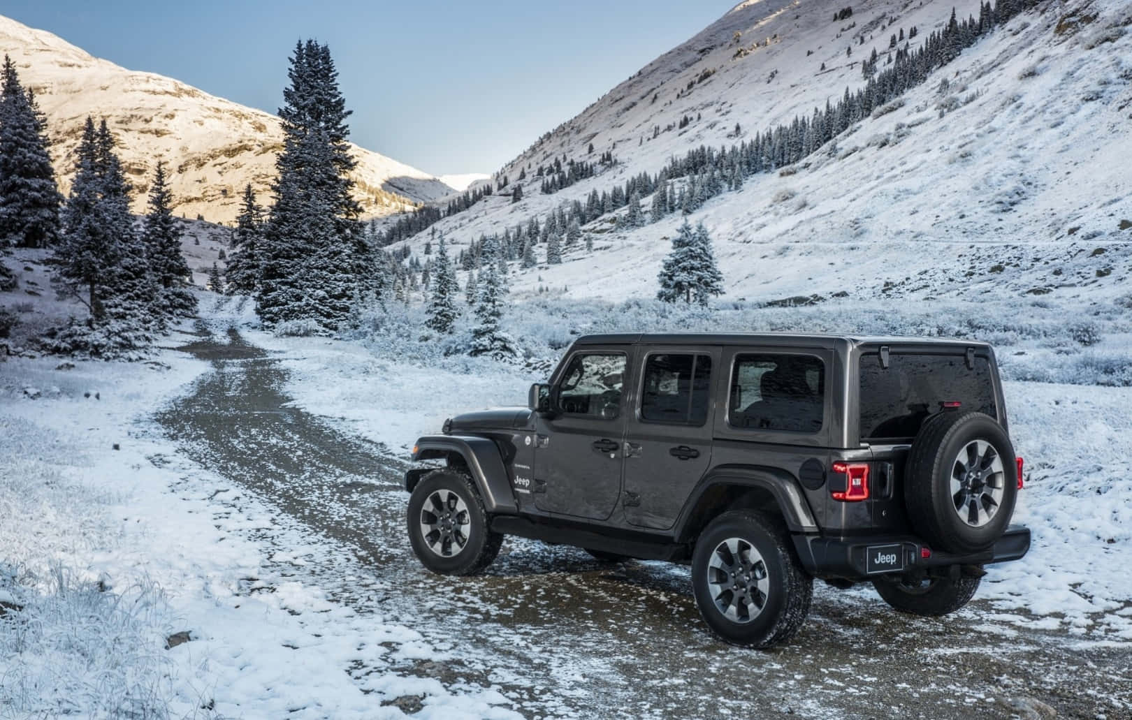 The 2019 Jeep Wrangler Is Driving Down A Snowy Road