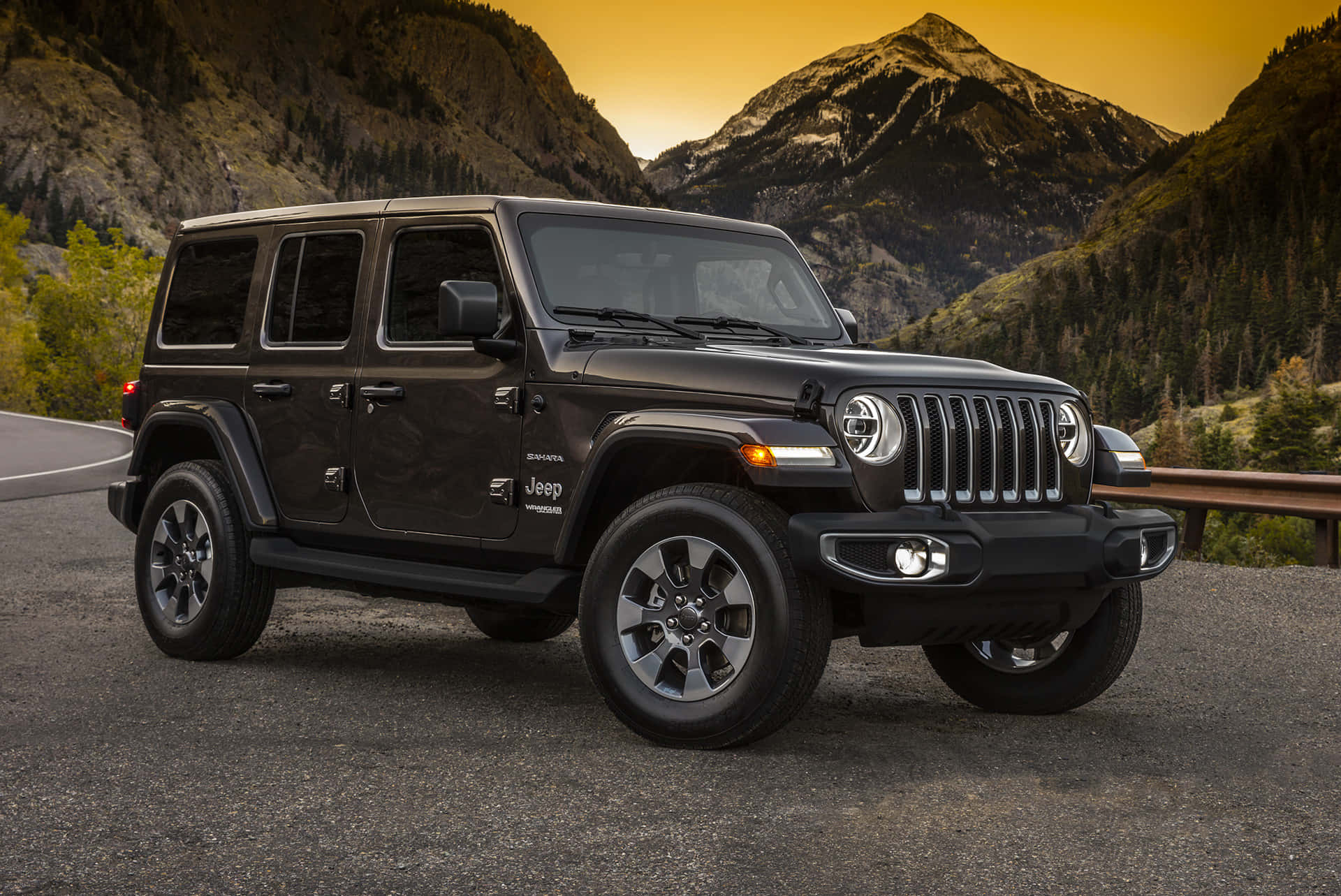 The Black Jeep Wrangler Is Parked On A Mountain Road