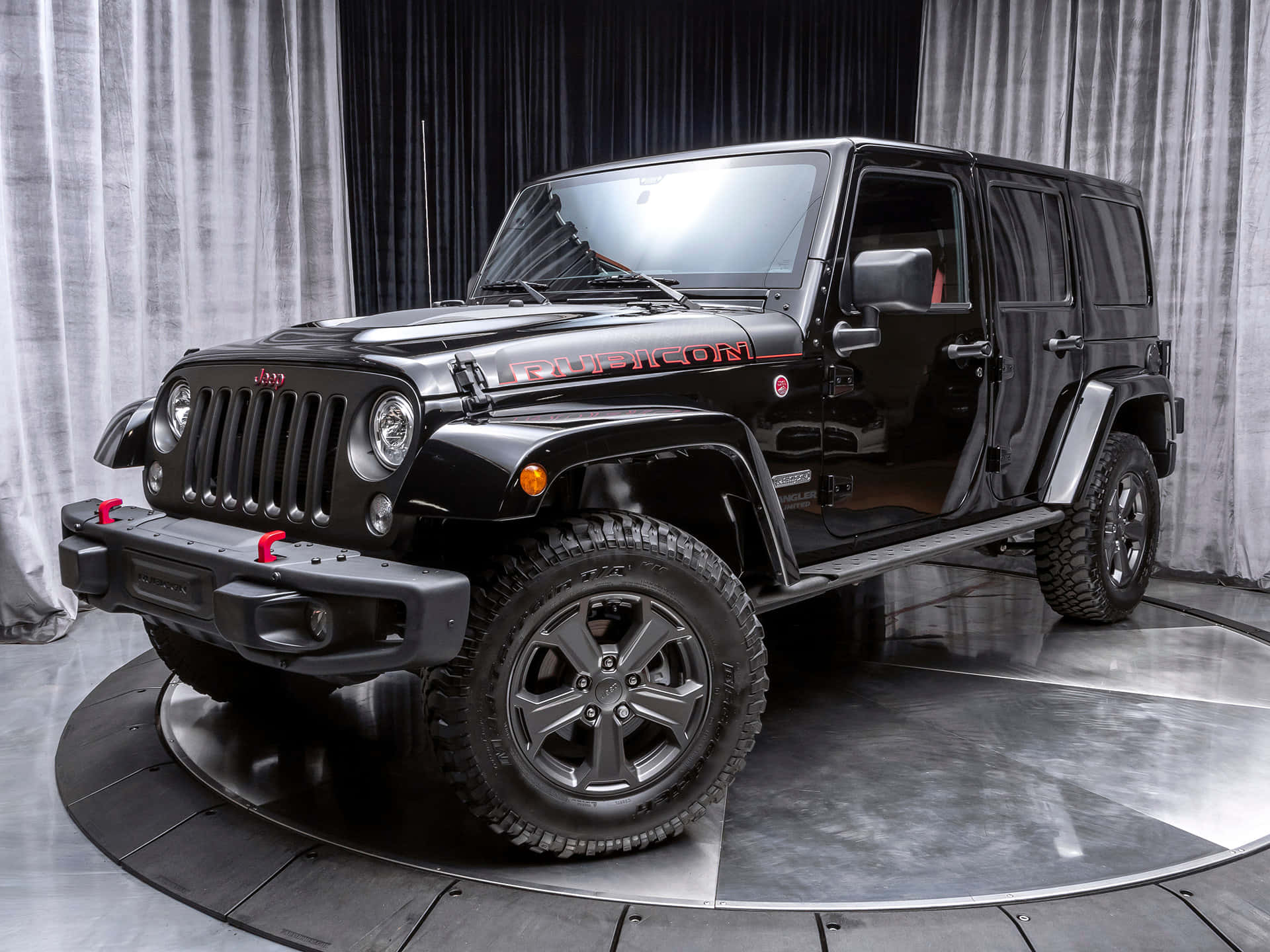 A Black Jeep Is Parked On A Circular Platform