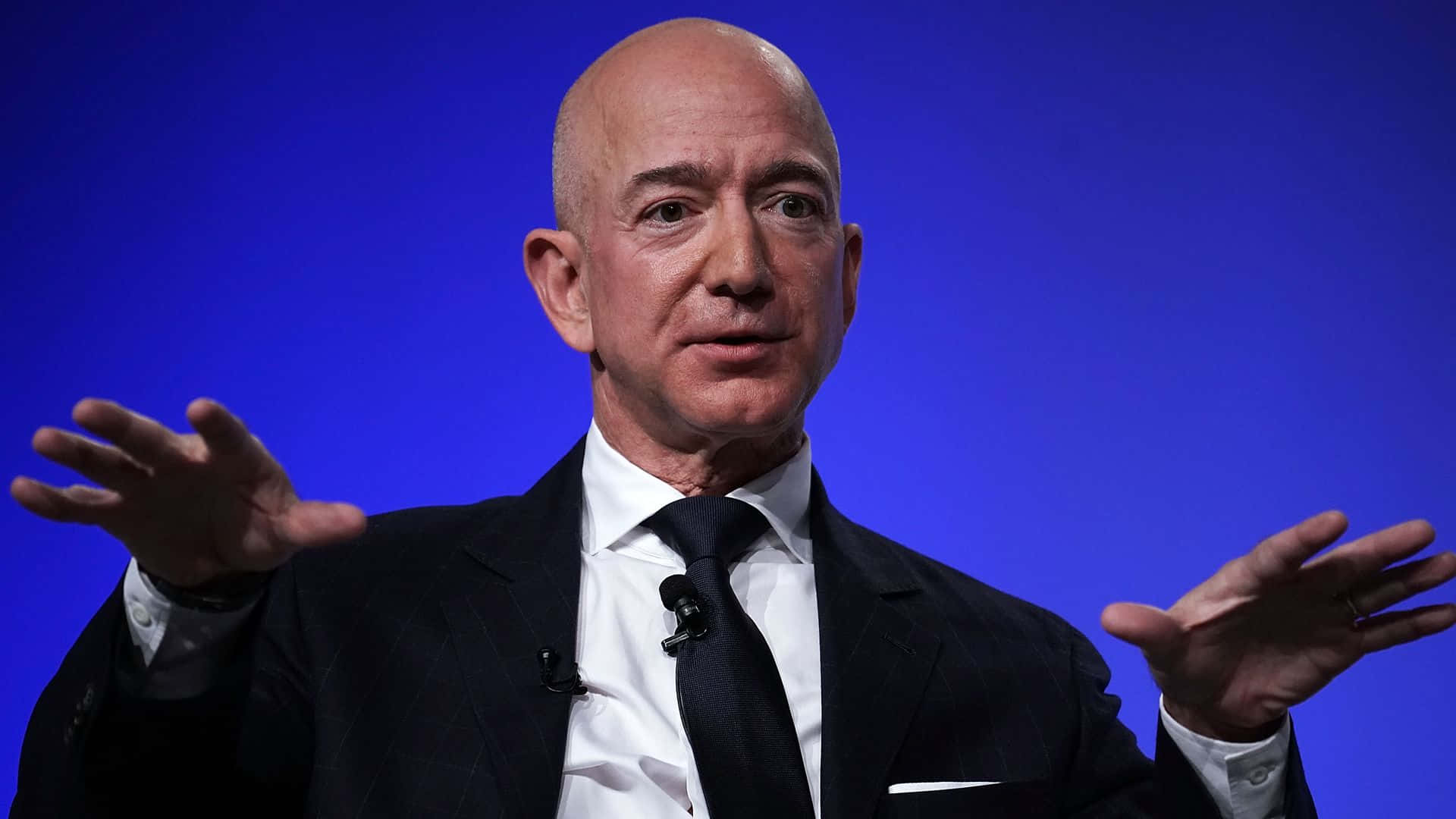 Jeff Bezos Smiling on a Neutral Background