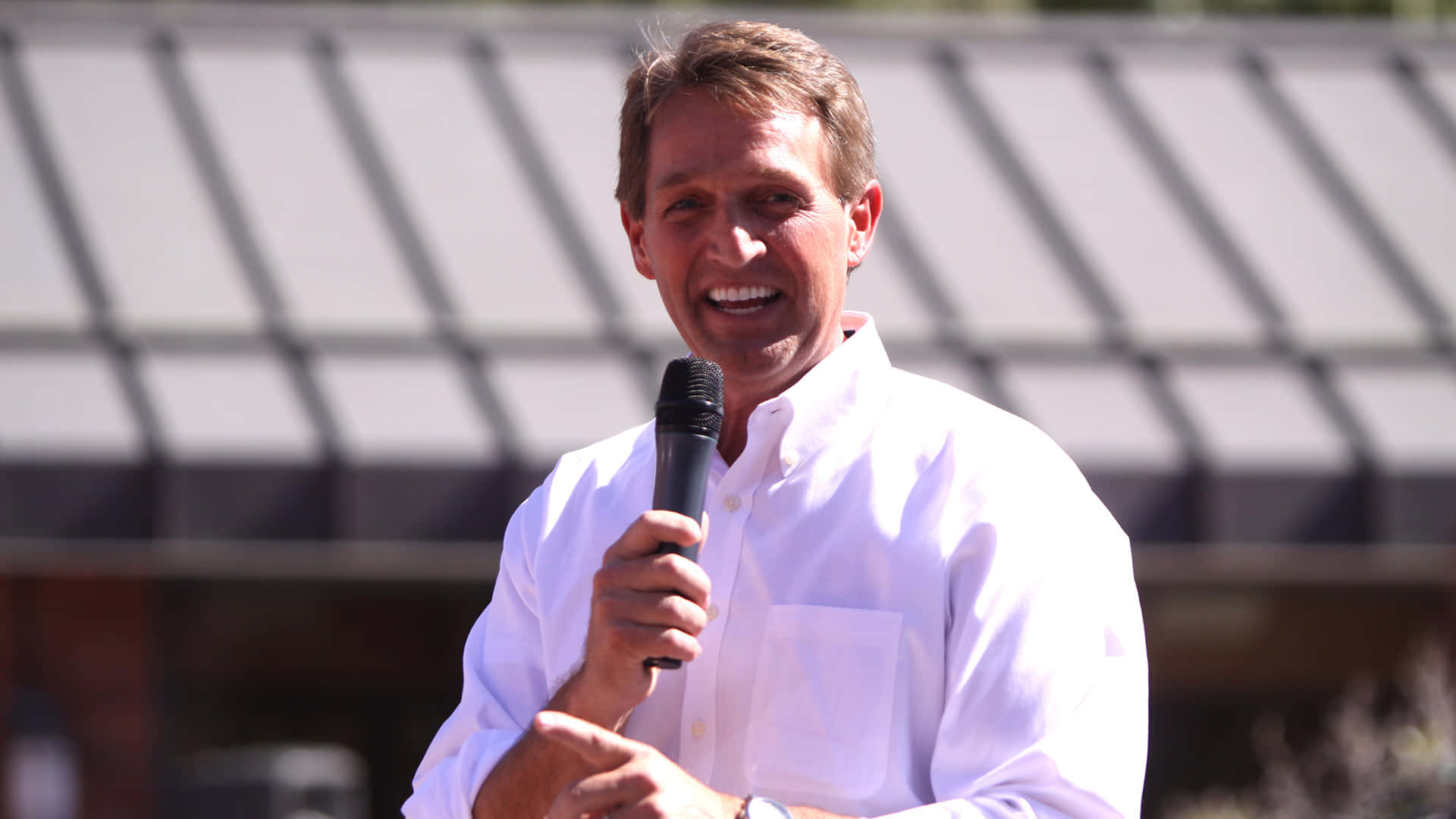 Jeff Flake Smiling While Holding Microphone Wallpaper