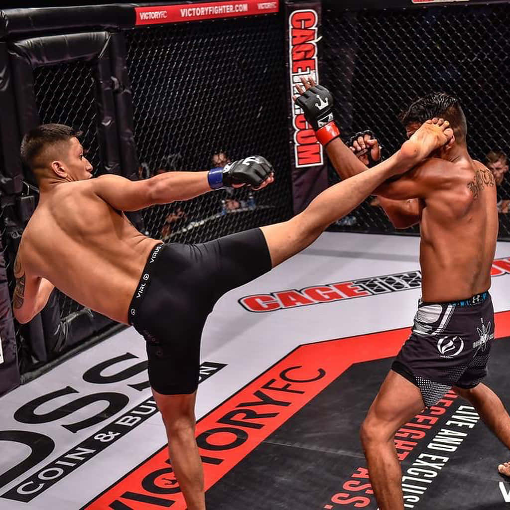 Dynamic action shot of MMA fighter Jeff Molina landing a high kick Wallpaper
