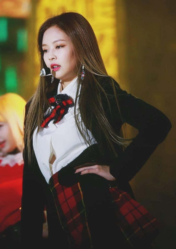 Singer and songwriter Jennie Kim posing in front of a crowd during a music showcase.
