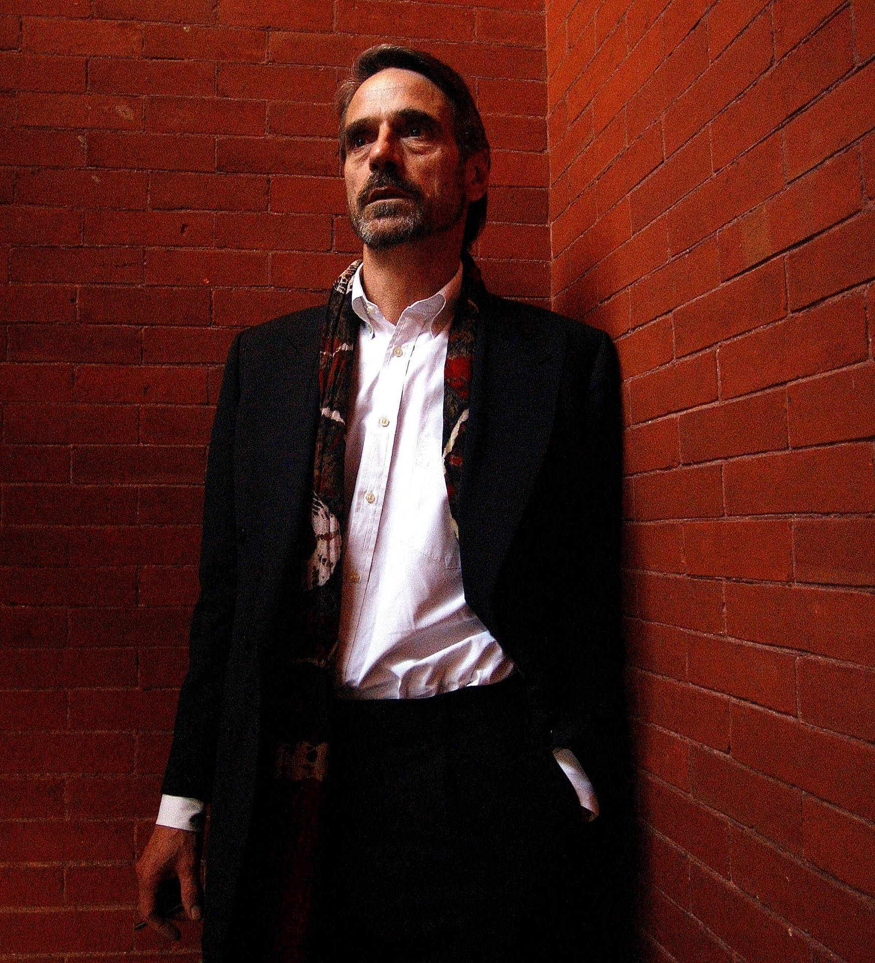 Jeremy Irons With Brick Wall Wallpaper