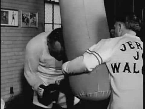 Jersey Joe Walcott Leans On A Punching Bag Wallpaper