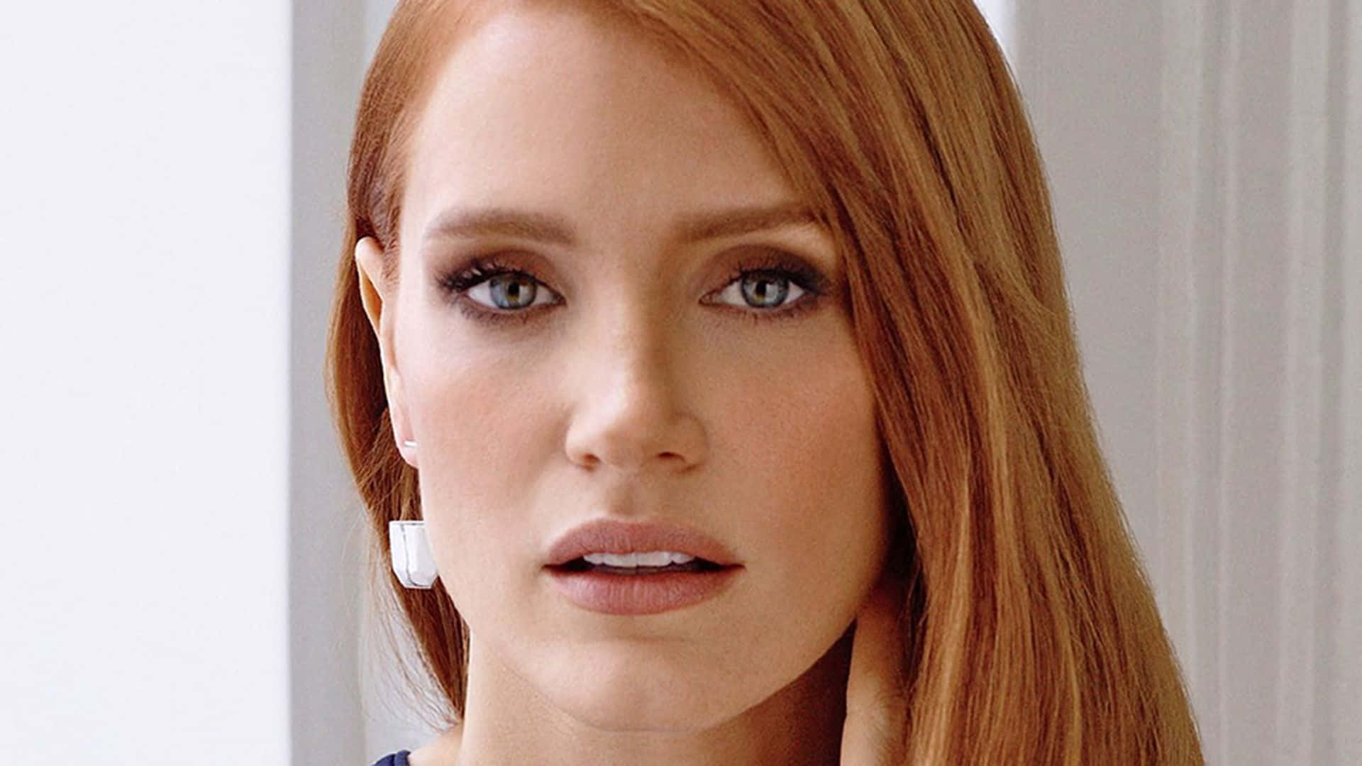 Jessica Chastain posing elegantly in a close-up portrait Wallpaper