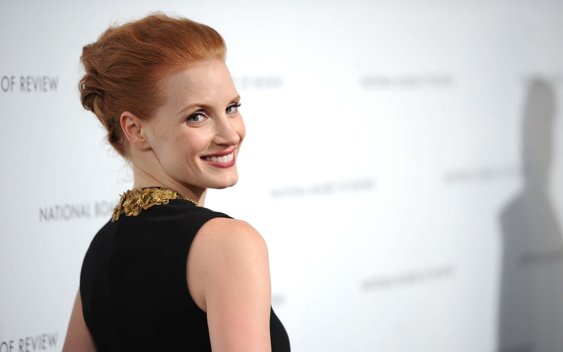 Jessica Chastain posing in a stylish outfit Wallpaper