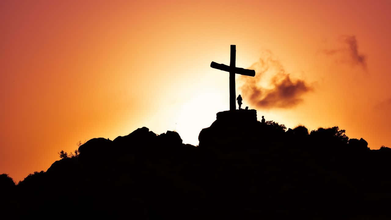 Jesus på korset med orange himmel billeder