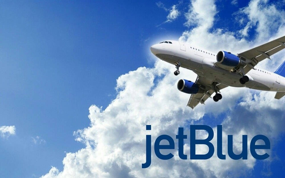 Aviãoda Companhia Aérea Jetblue Airways No Céu. Papel de Parede