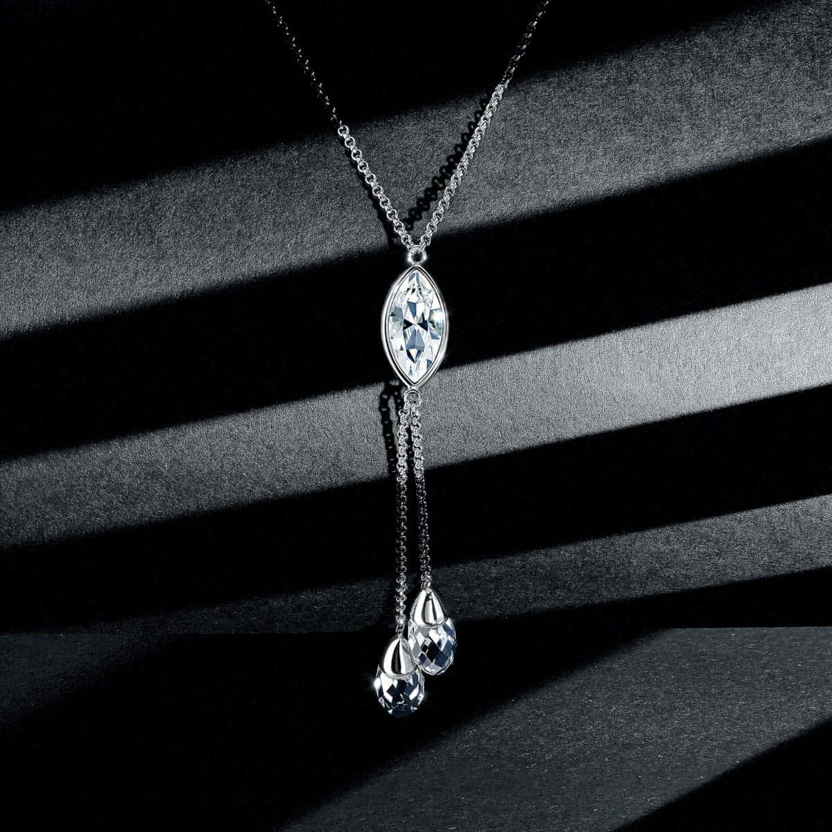 A Necklace With A Diamond Pendant On It
