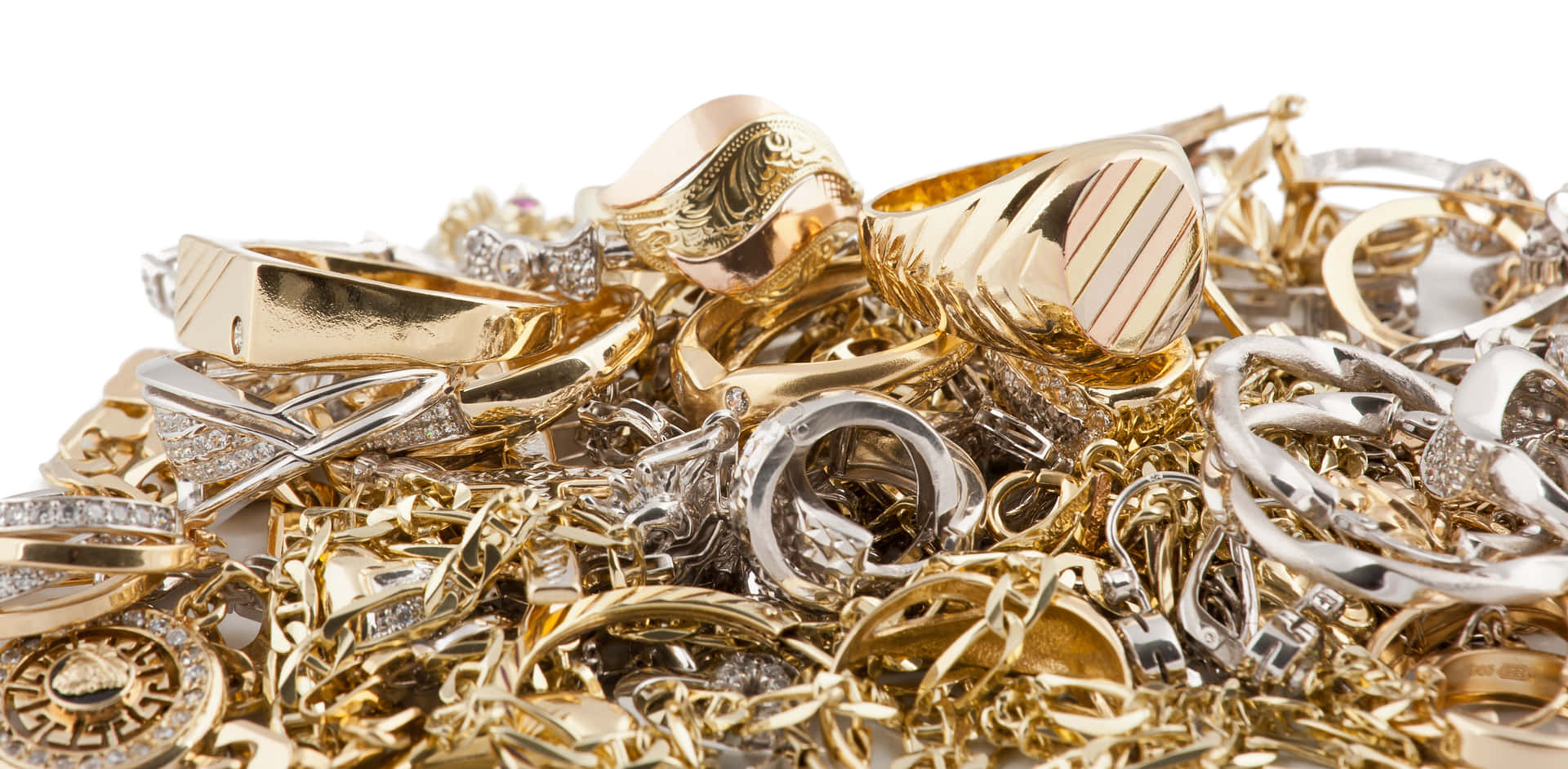 A Pile Of Gold And Silver Jewelry
