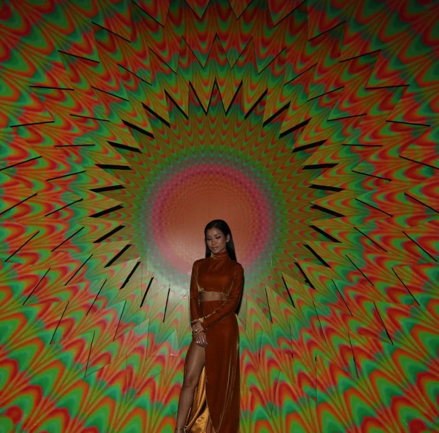 Jhene Aiko posing artistically in colorful dress Wallpaper