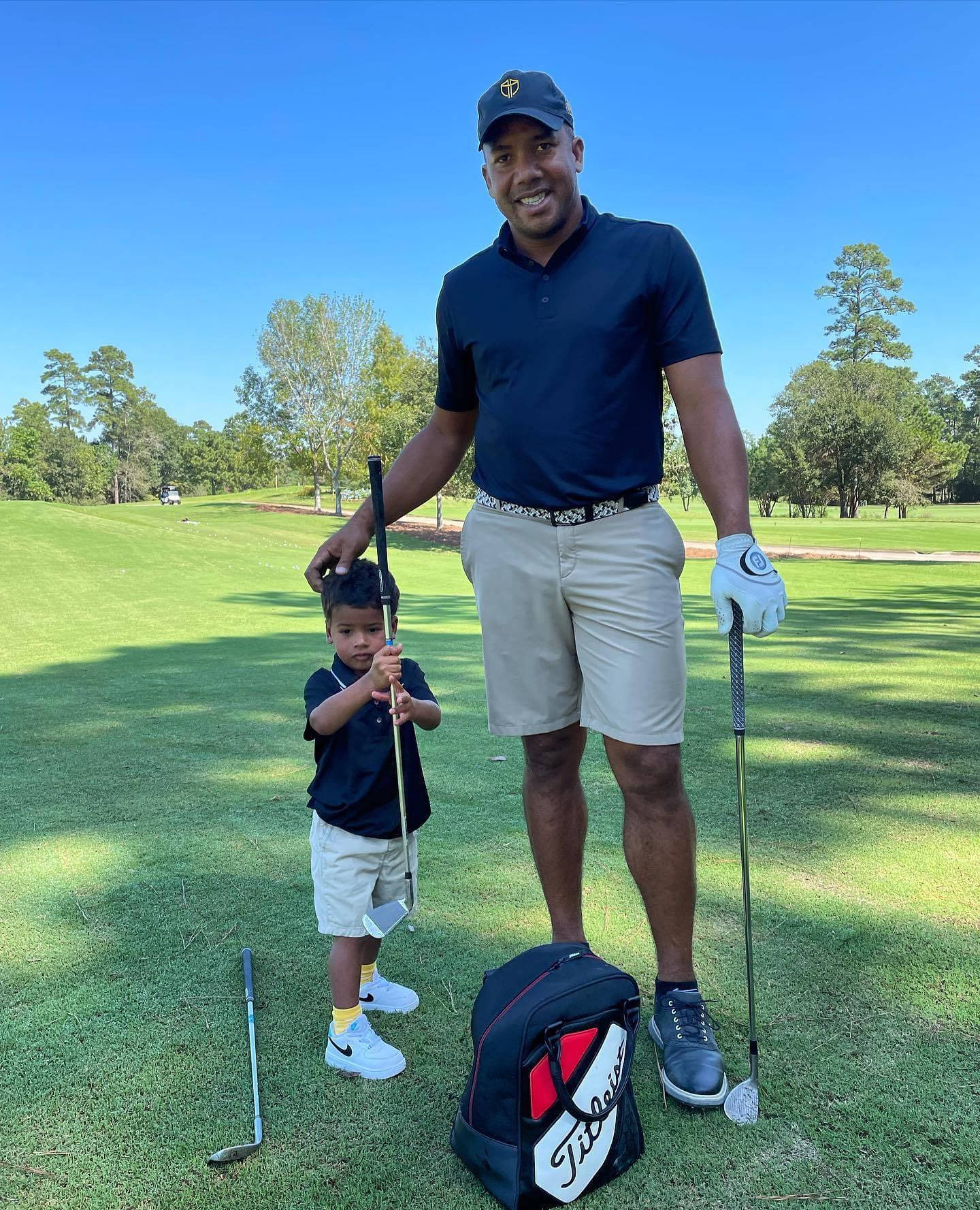 Jhonattan Vegas With Son On Golf Course Wallpaper
