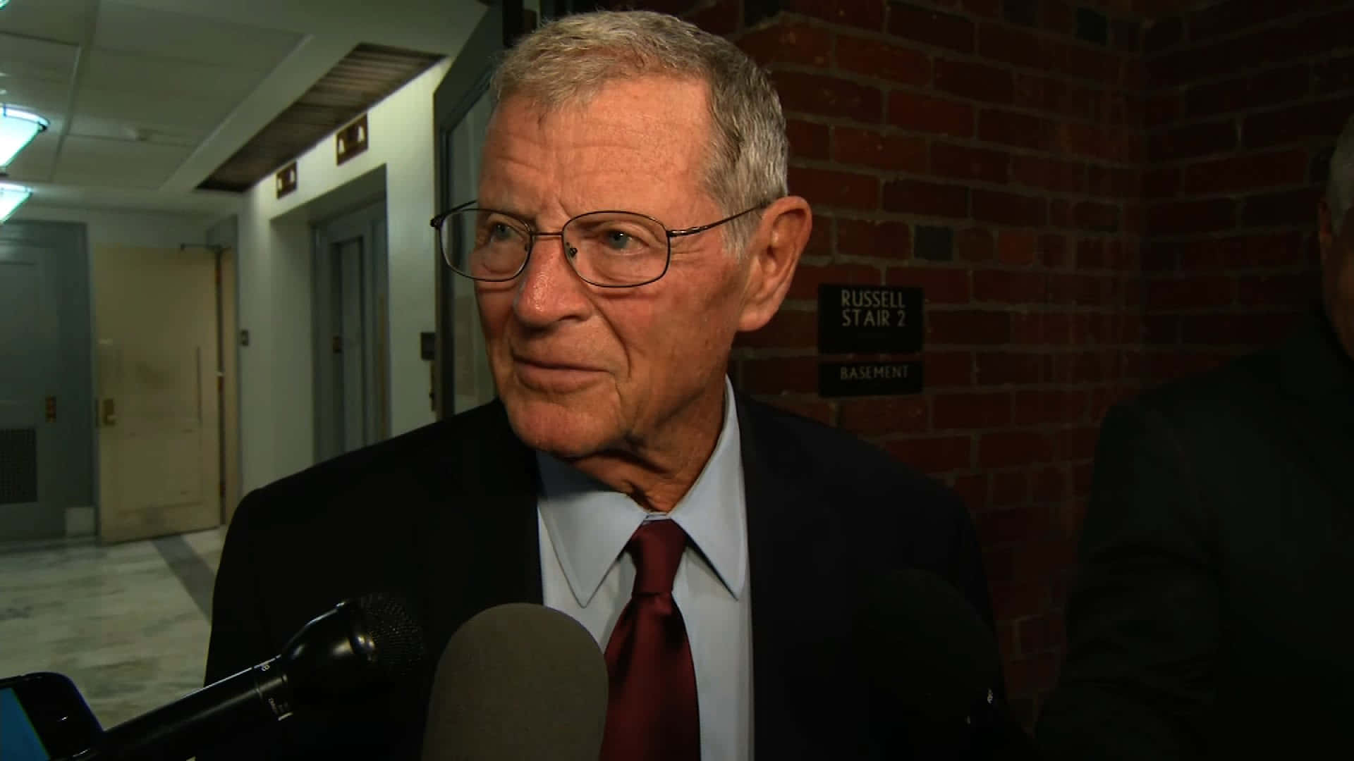 Jim Inhofe With Two Microphones Wallpaper