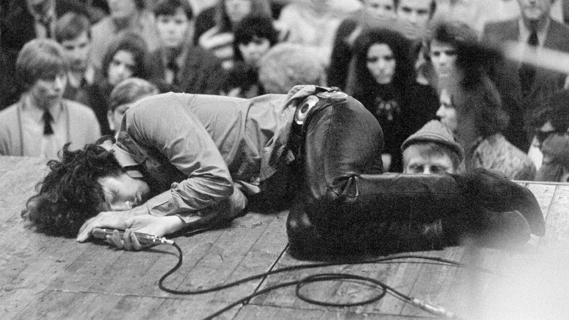 Iconic Image of Jim Morrison Asleep on Stage Wallpaper