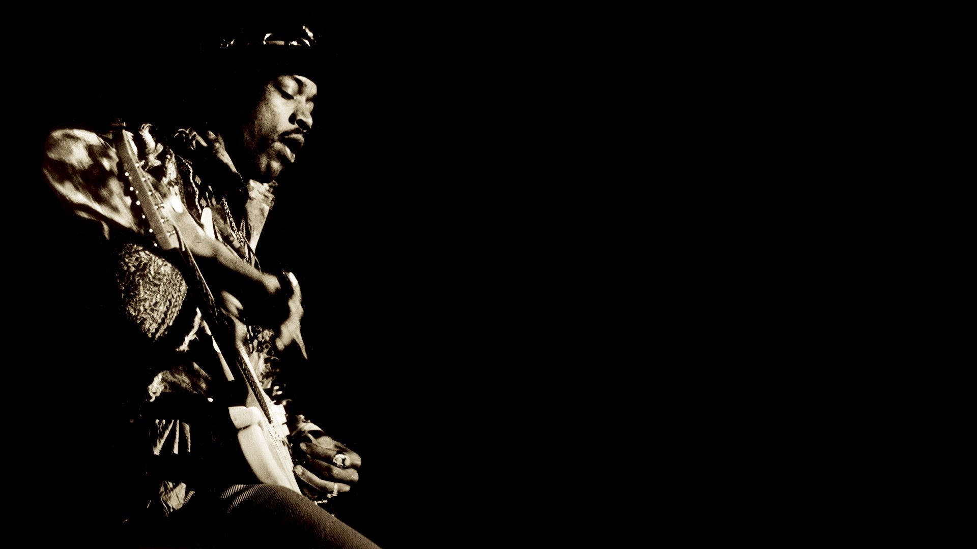 Jimi Hendrix Strumming Electric Guitar Wallpaper