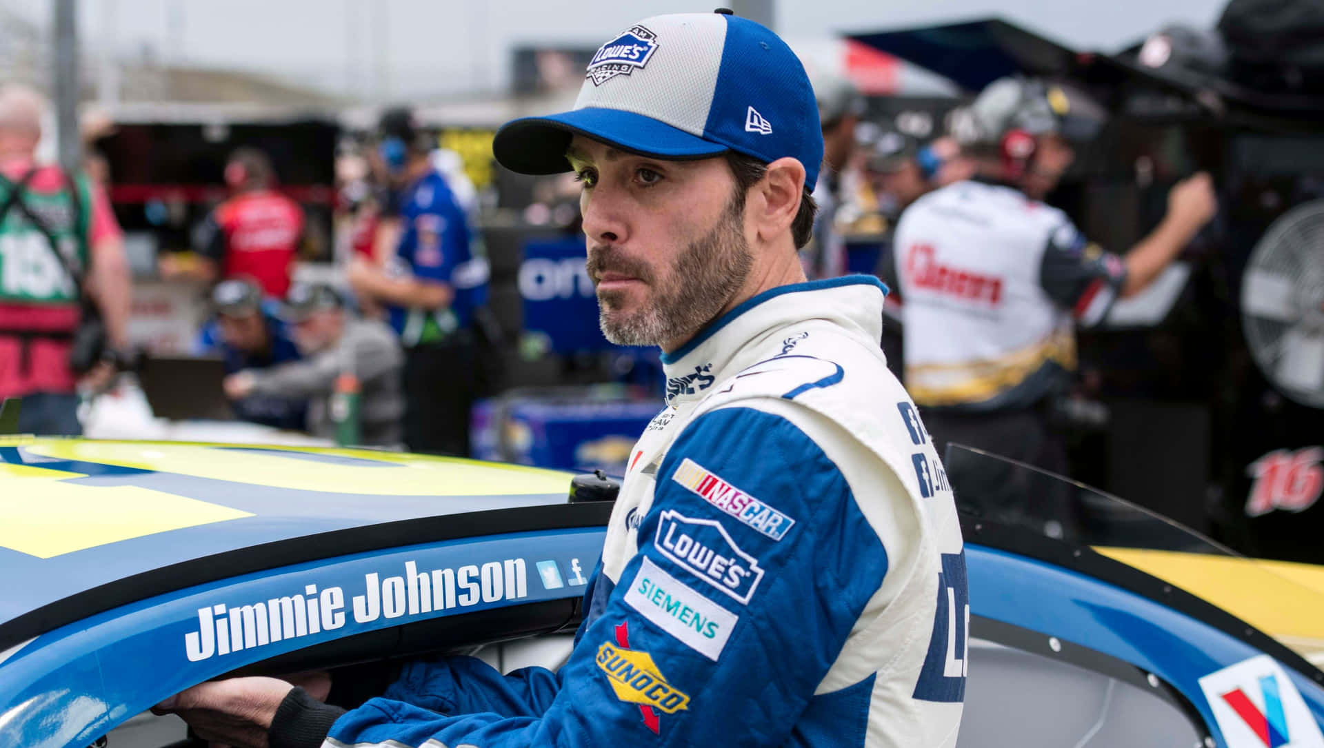 Jimmie Johnson racing on the track in his iconic car Wallpaper
