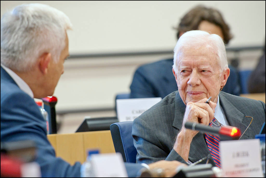 Former President Jimmy Carter Engaging in a Serious Discussion Wallpaper