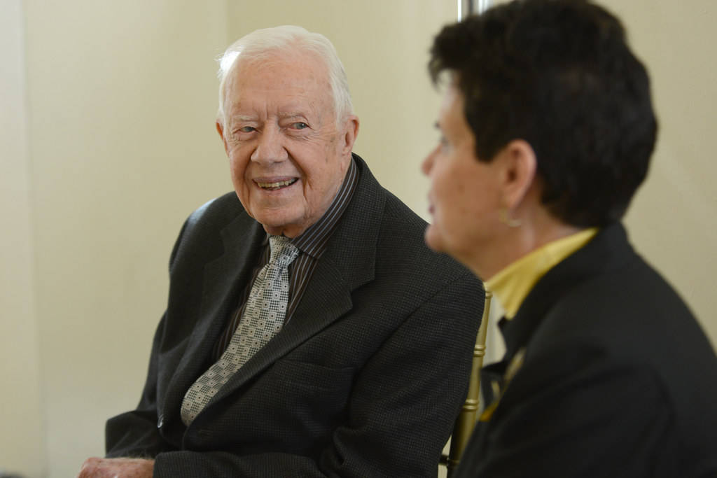 Former President Jimmy Carter Engaging in Conversation with a Woman Wallpaper