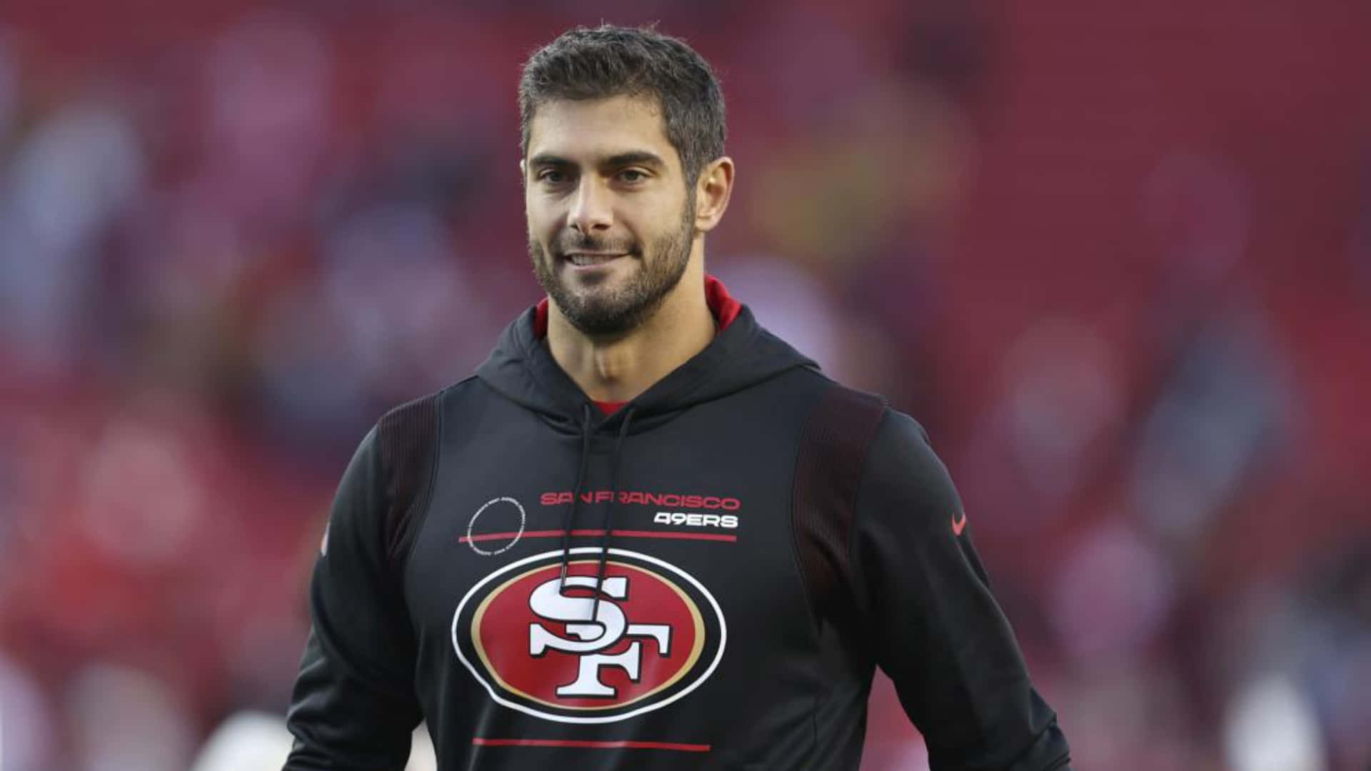 Jimmy Garoppolo confidently posing on the field Wallpaper