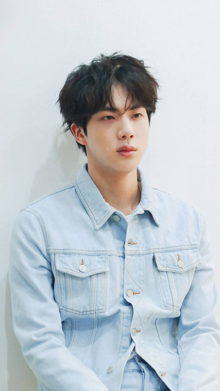 BTS Singer Jin Is Sitting In White Wall Background Wearing Blue Jeans Shirt  HD Jin Wallpapers, HD Wallpapers