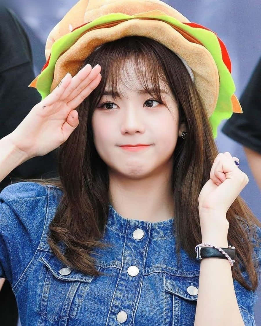 A Girl Wearing A Hat And A Hamburger