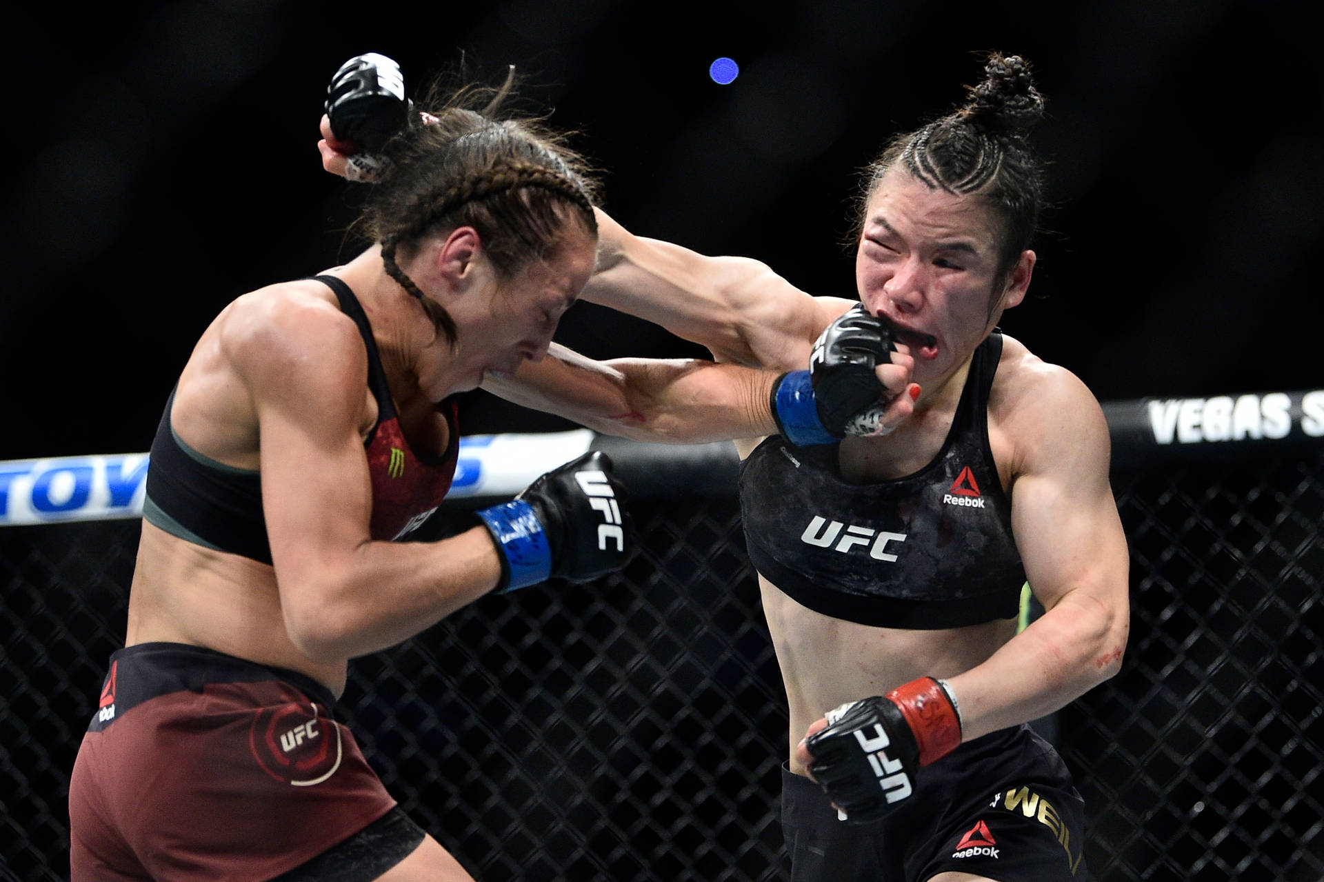 Caption: UFC Fighters Zhang Weili and Joanna Jedrzejczyk in Intensive Combat Wallpaper