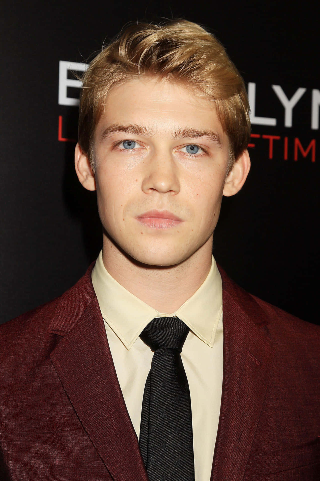 Joe Alwyn looking stylish in a classic black suit." Wallpaper