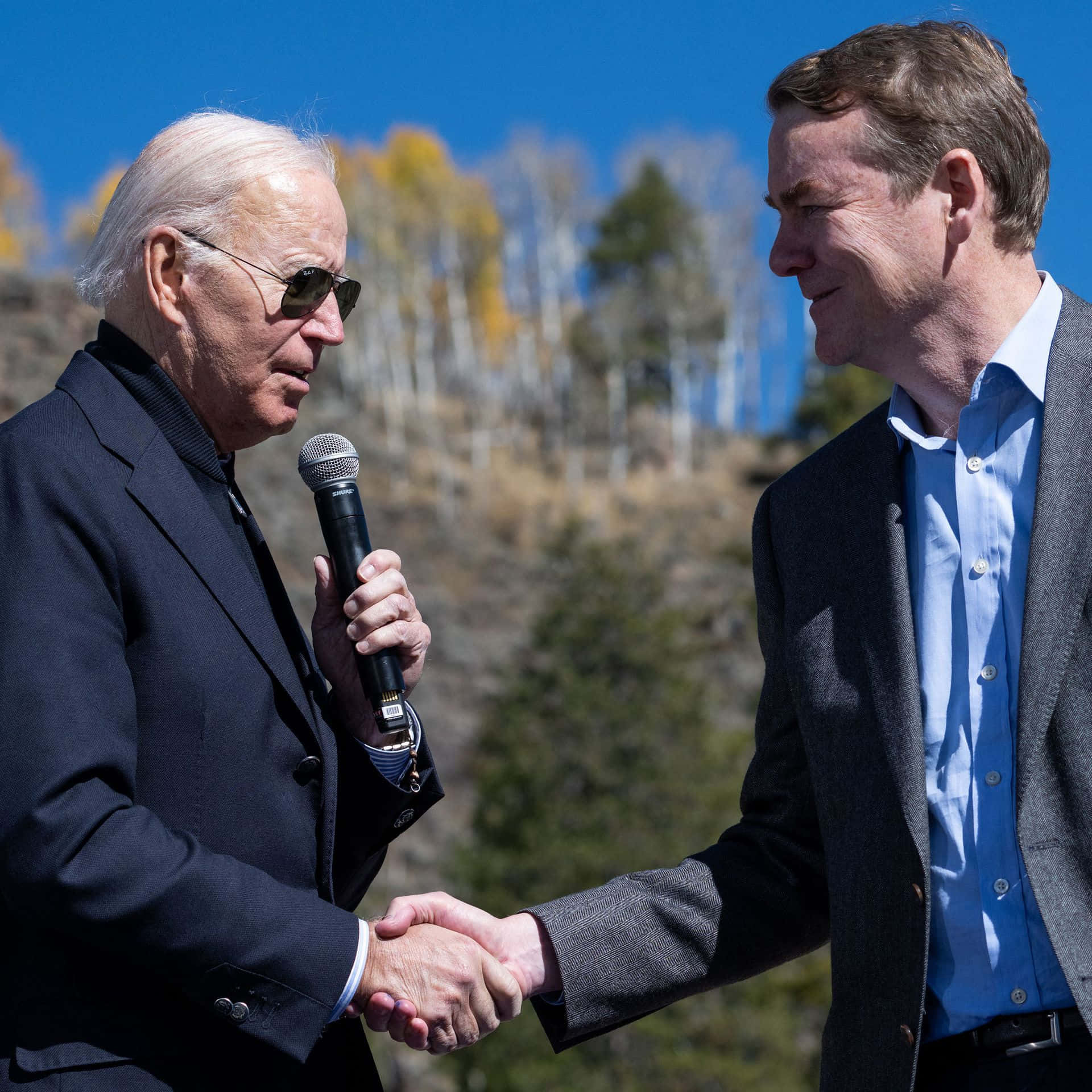 Senator Michael Bennet shaking hands with Joe Biden. Wallpaper