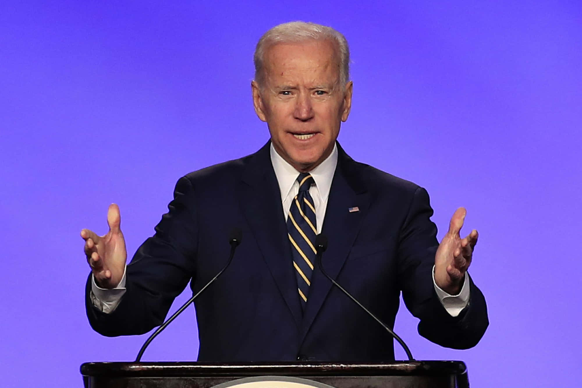 Biden Speaks At A Podium With His Hands Out