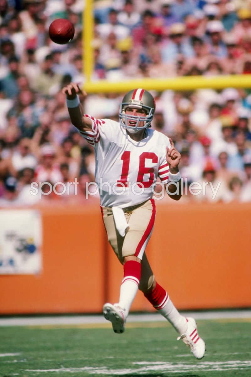 Legendary NFL quarterback Joe Montana throwing a touchdown pass Wallpaper