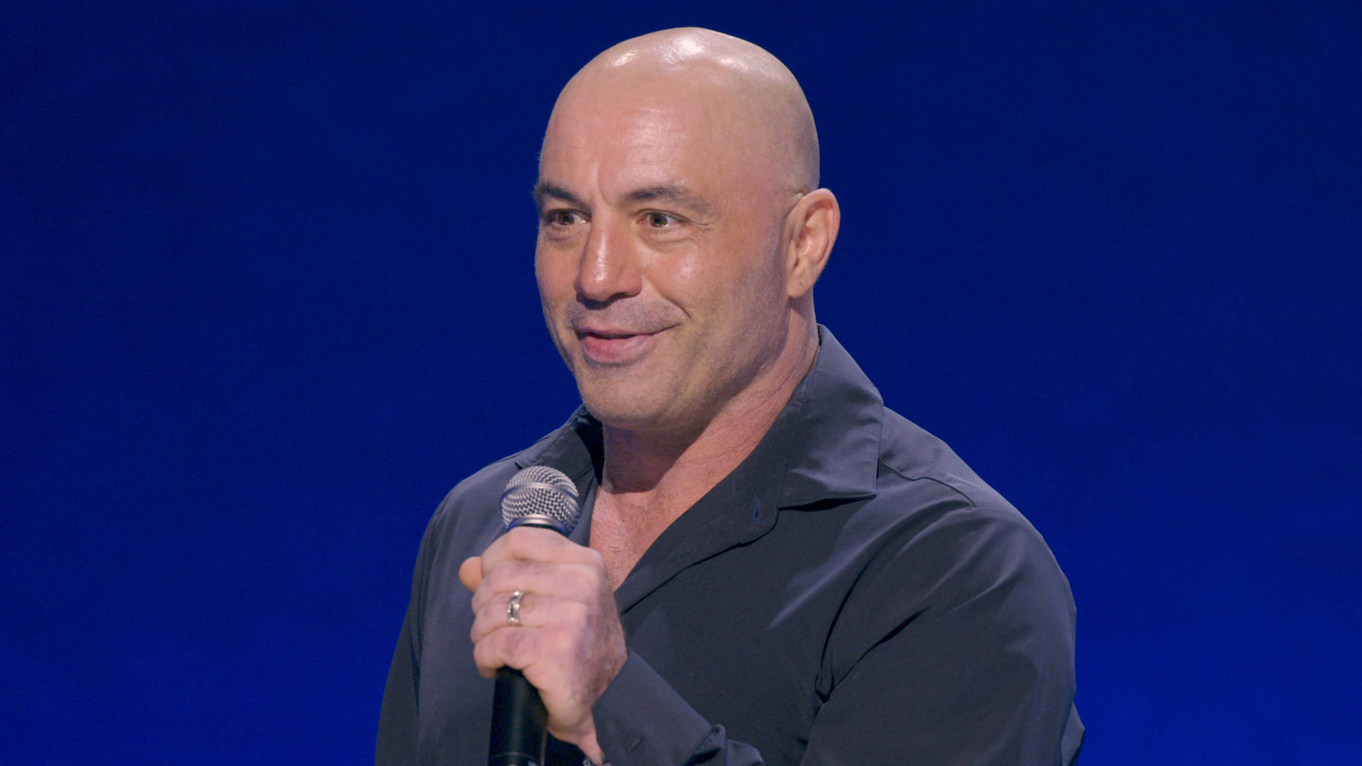 Joe Rogan Intensely Performing Stand-up Comedy Wallpaper