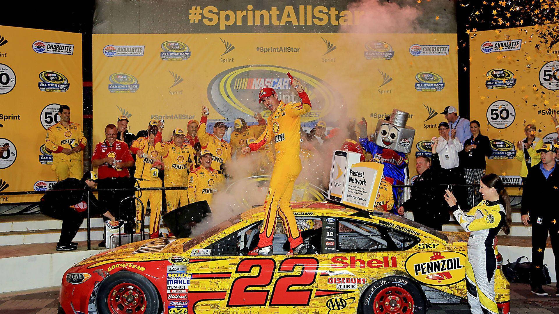 Joey Logano Celebrating Victory with His Team Wallpaper