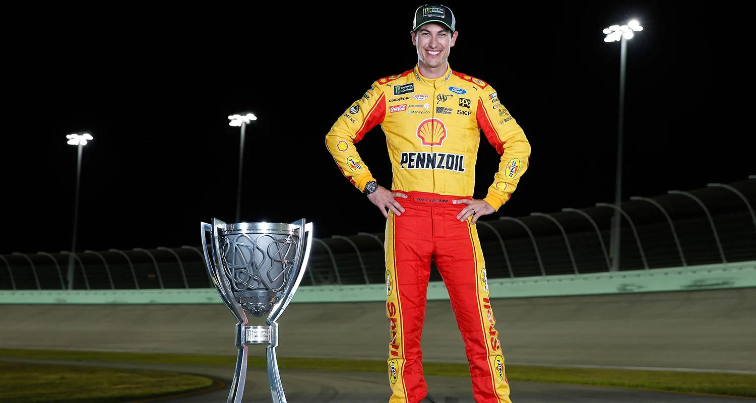 Champion Joey Logano with Trophy Wallpaper