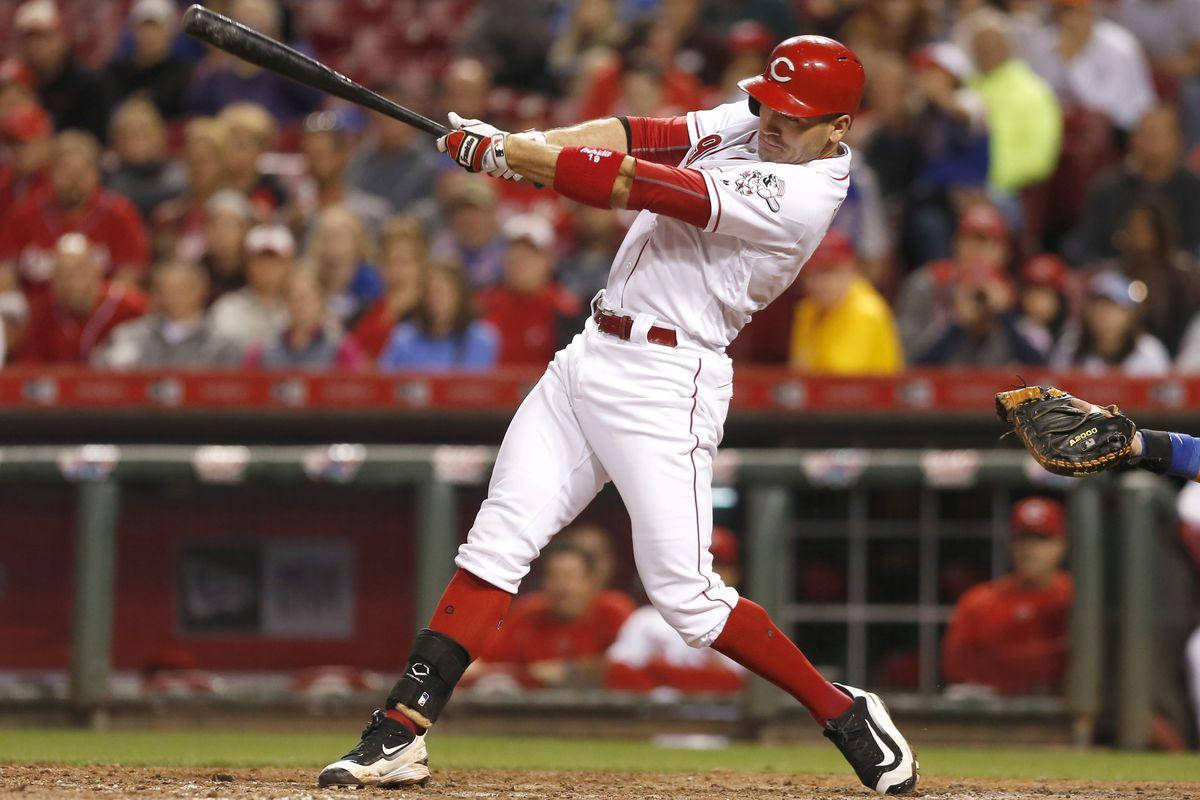 Download Joey Votto in the heat of a powerful swing Wallpaper