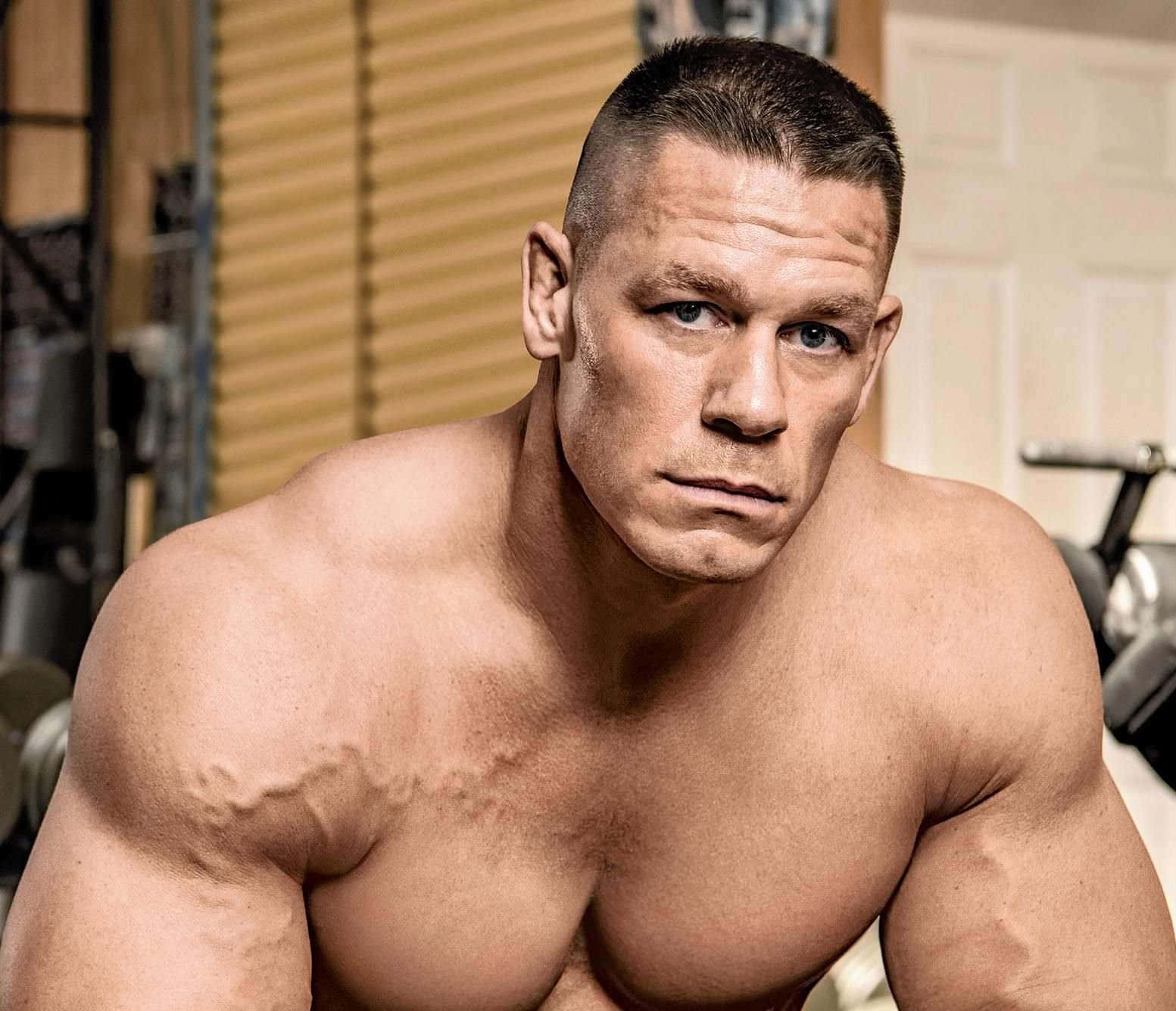 John Cena flexing muscles during a WWE match
