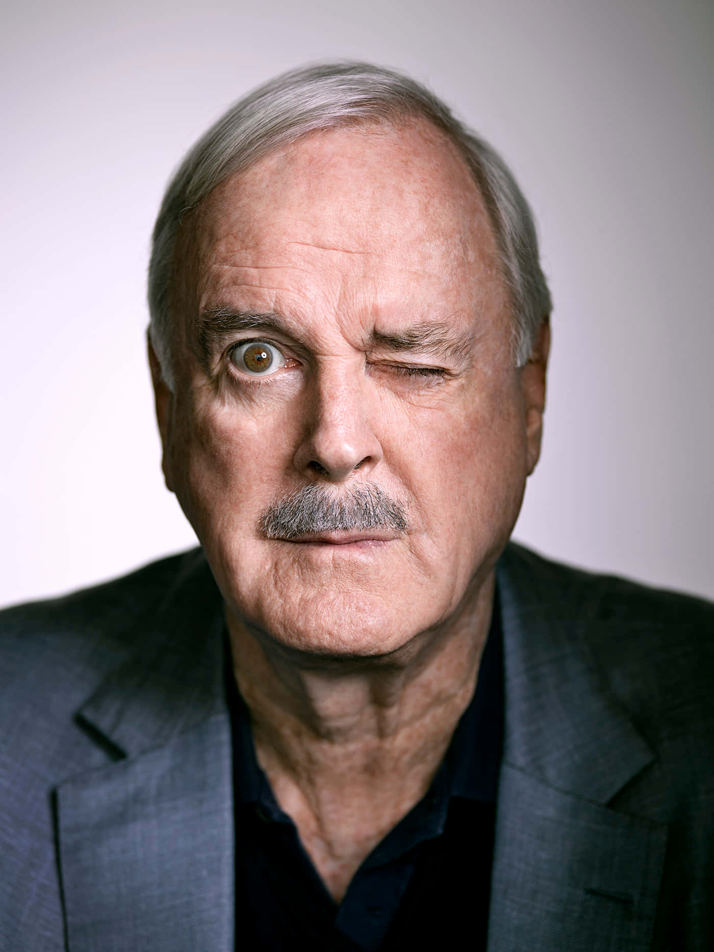 John Cleese Performing On Stage Wallpaper