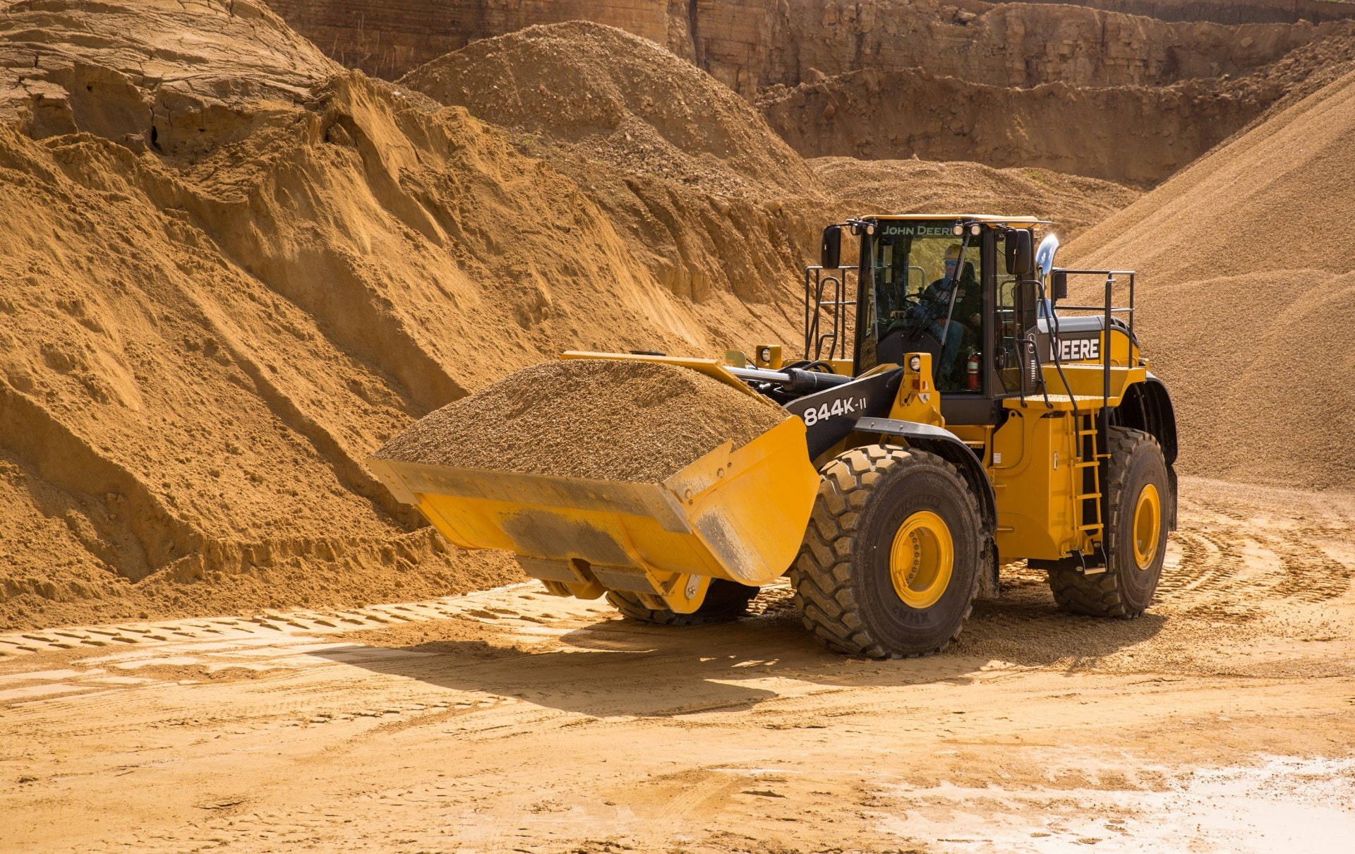 A powerful John Deere Wheel Loader in action at the construction site. Wallpaper