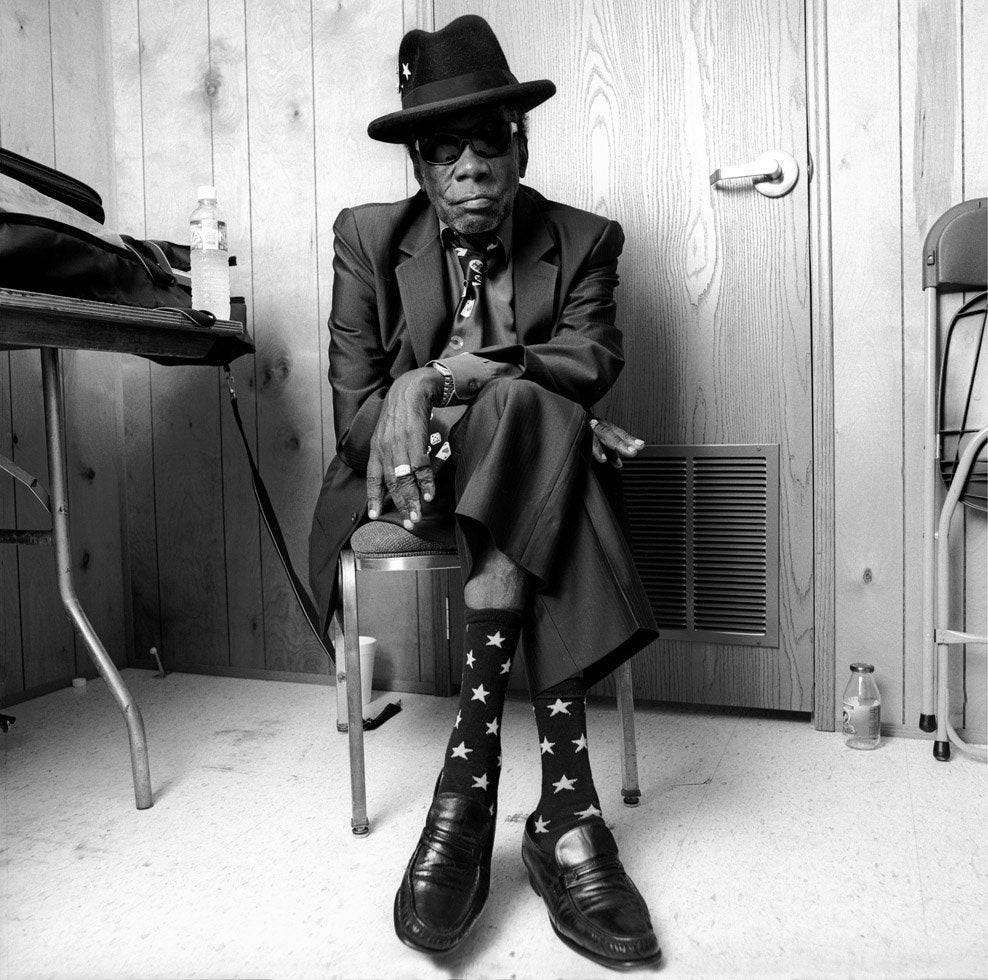 John Lee Hooker Sitting With Legs Crossed Wallpaper