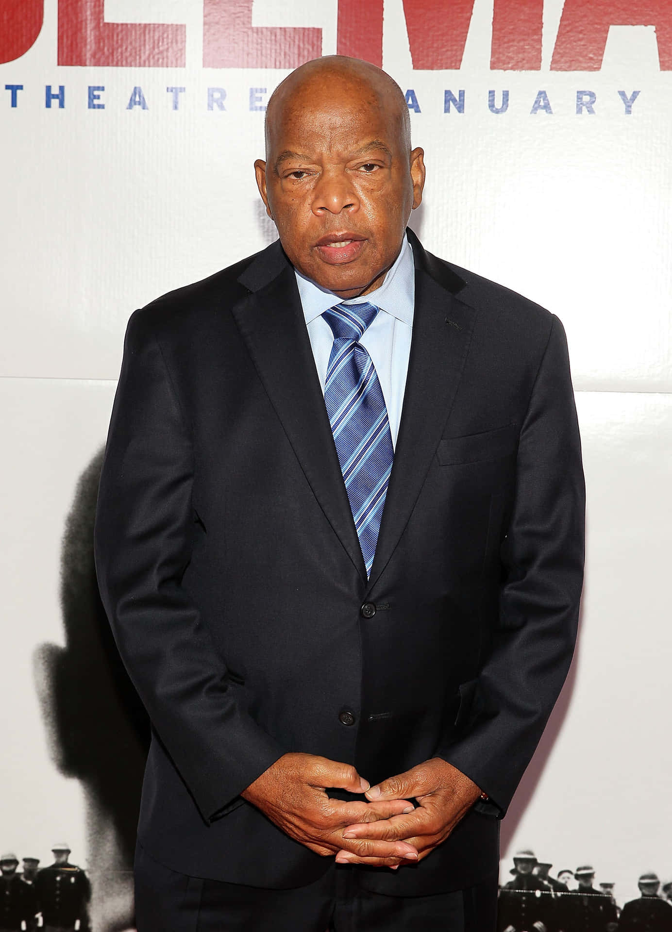 Civil Rights Icon John Lewis Standing Proudly in Front of Selma Poster Wallpaper