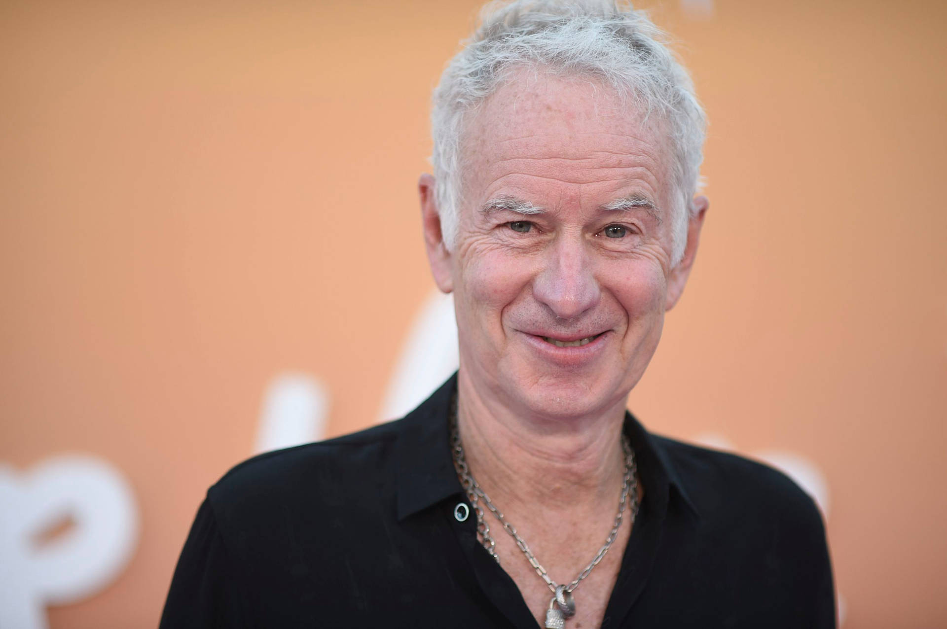 Johnmcenroe Ler. (assuming This Is A Statement That Could Be Used As A Description For A Computer Or Mobile Wallpaper Featuring An Image Of John Mcenroe Smiling.) Wallpaper