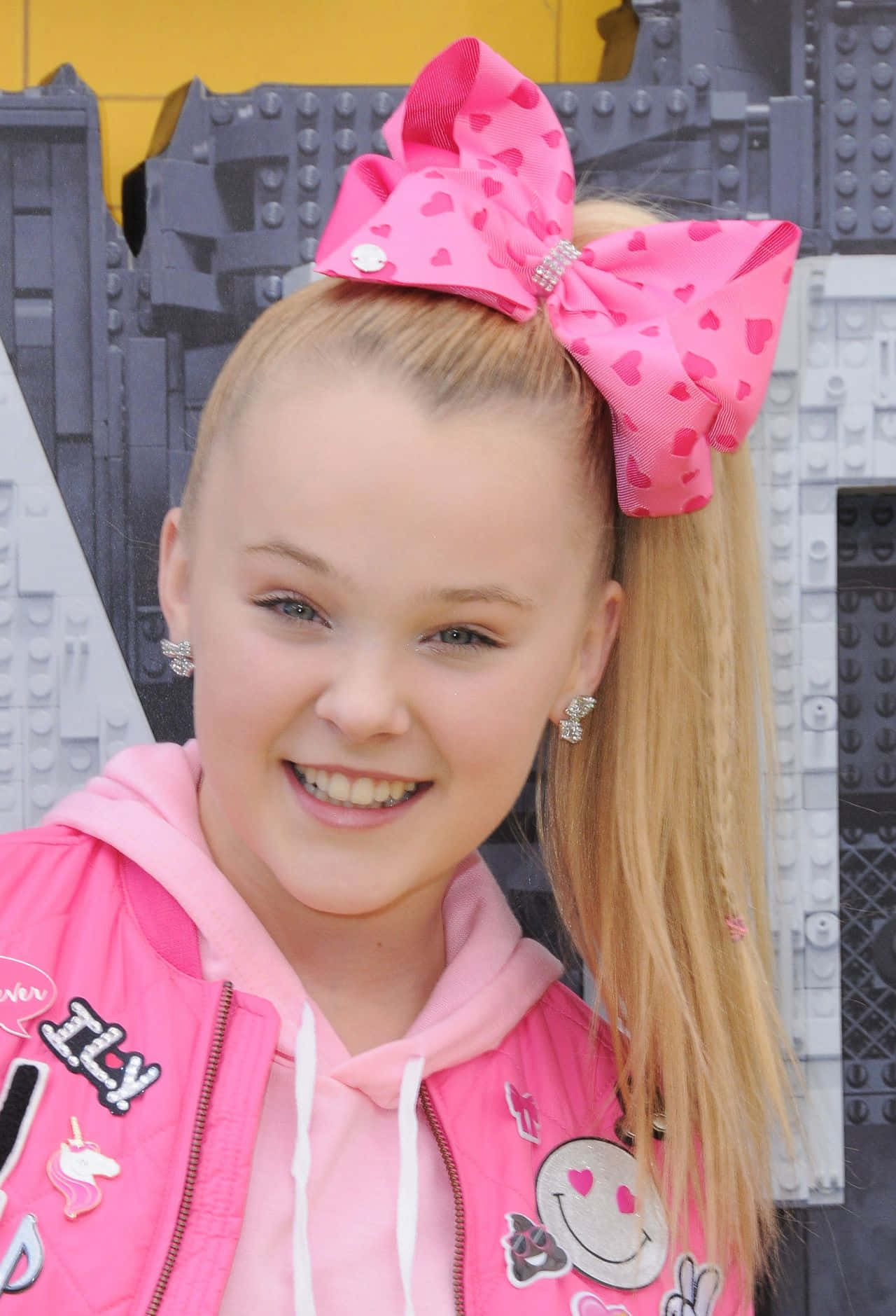 A Girl In Pink Jacket And Bow - Front